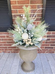 a potted plant sitting on top of a wooden floor next to a brick wall