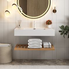 a bathroom with a sink, mirror and towels on the shelf in front of it