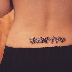 a woman's stomach with three dogs tattoo on the lower part of her belly