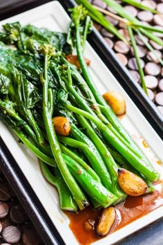 green beans and broccoli on a white plate