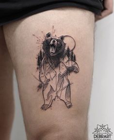 a black and white bear tattoo on the thigh