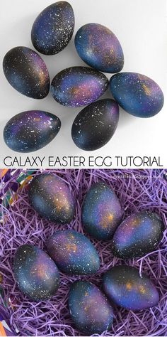 an easter egg with galaxy painted on it and purple eggs in the middle, sitting next to each other