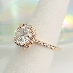 a diamond ring on top of a white napkin with a blurry background behind it