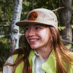 Get Fired Up for Adventure with this Campfire Cap! The patch on this hat features a classic campfire scene, capturing the timeless allure of the great outdoors. It's a simple yet evocative image: two logs ablaze with flames reaching upwards, cradled by a circle that hints at the unity and completeness of nature. The trees standing sentinel on either side anchor the scene in the wild, calling to mind the serenity of the woods and the simple pleasures of a fireside chat under the stars. Each cap i Campfire Scene, Jockey Hat, Field Notes Cover, Moleskine Cover, Fisher Space Pen, Space Pen, Leather Mouse, Leather Mouse Pad, Oxblood Leather