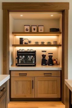 a coffee maker is sitting on the counter in front of some shelves with cups and other items