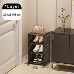 the four tier shoe rack is next to a cabinet with two shoes on it and a plant