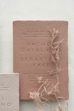 the wedding stationery is made out of pink paper and embossed with silver foil