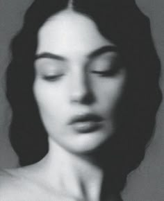 a black and white photo of a woman with her eyes closed