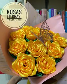 a bouquet of yellow roses with a butterfly on the top in front of bookshelves