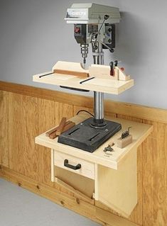 a workbench with a driller and tools on it