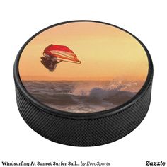 an image of a person parasailing in the ocean at sunset or sunrise time