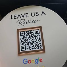 a close up of a qr code on a round object with the words leave us a review