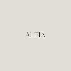 the word aleia written in black ink on a light gray background with white lettering