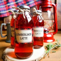 three bottles of lumber latte sitting on top of a wooden table