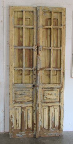 an old wooden double door with glass inserts