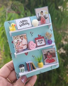 a hand holding up a card with pictures on it and magnets attached to the back