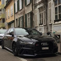 a black car parked on the side of a street