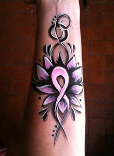 a woman's arm with a pink ribbon and flower tattoo design on the wrist