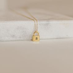 I N I T I A L * P A D L O C K * N E C K L A C E * Material: High Quality Solid 925 Sterling Silver * Finish: Sterling Silver ∙ 18K Gold ∙ Rose Gold * Dimensions: 12mm x 8mm Padlock Pendant * All our work is custom made by hand with Love and Care in our workshop ♡ H O W ∙ T O ∙ O R D E R * Just use the 'PERSONALIZATION BOX' to let us know the LETTER/INITIAL and Font Number you would like on the charm. ♥ YOUR LETTER/INITIAL + FONT NUMBER ♥ * If a font is not given, you will receive the font that i Initial Fonts, Padlock Necklace, Initial Pendant Necklace, Minimalist Gifts, Initial Pendant, Christmas Gifts For Her, Solid 925 Sterling Silver, Personalized Jewelry, Jewelry Gift