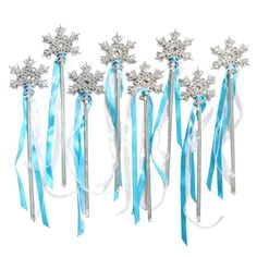 six snowflake wands with blue ribbons and bows on them, all lined up in a row