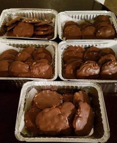 four pans filled with chocolate covered cookies on top of a table