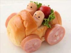 a toy car made out of bread with meat and vegetables