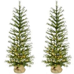 two artificial christmas trees with lights on them