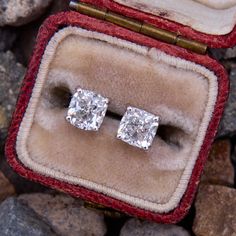 This lovely pair of square cushion diamond stud earrings are each accented with one (1) cushion cut diamond set into a four-prong setting. The earrings are finished with friction backs and posts for pierced ears. Rectangular Diamond Earrings With Accents For Formal Events, Formal Rectangular Diamond Earrings With Accents, Luxury Rectangular Diamond Earrings With Accents, Rectangular Diamond Earrings For Formal Events, Rectangular Diamond Earrings For Formal Occasions, Luxury Rectangular Diamond Cut Earrings, Formal White Gold Diamond Earrings Rectangular, Formal Rectangular White Gold Diamond Earrings, Formal Rectangular Earrings With Diamond Accents