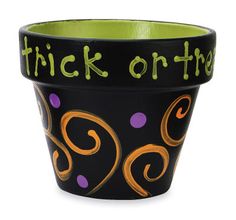 a black and green flower pot with the words trick on the inside