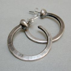 "Silver hoop earrings, I hammered the hoop of wire, then I soldered it to a half silver granule, and to the back, I soldered a pin. They are light, with a simple and clear design, suitable to be worn on many occasions weight 0.10 oz length 1.18\" width1.18\" Simple jewel, but made original by craftsmanship, which adds value and features to each of my pieces. Thank you for visiting my shop, if you like to receive news and updates please save me in your favs you can find me on Instagram; @Petrahje Hoop Earrings Handmade, Hammered Hoop Earrings, Sterling Silver Hoop Earrings, Sterling Silver Hoops, Silver Hoops, Silver Hoop Earrings, Handmade Earrings, Earrings Handmade, Heart Ring