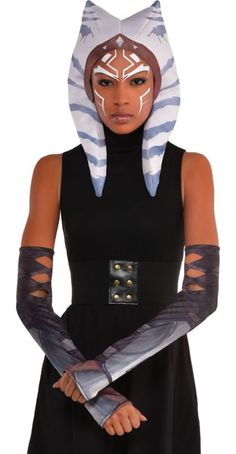 a woman in a star wars costume is holding two large knives and wearing a cat mask