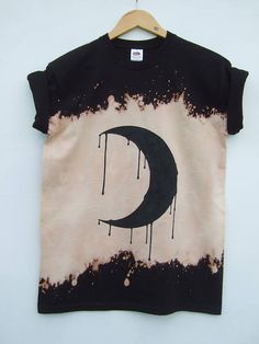 a black and white t - shirt with dripping paint on it