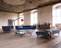 a living room filled with furniture and windows