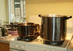 two pots are sitting on top of the stove