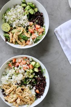 two white bowls filled with rice, black beans and veggies next to each other