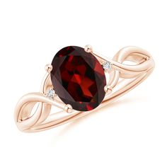 a ring with a large red stone in the center and two diamonds on each side