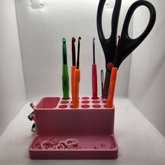 scissors and other office supplies in a holder