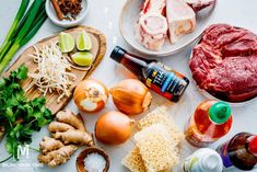 the ingredients are laid out on the table to be prepared for this meal, including meats and vegetables