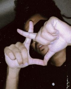 a person making the peace sign with their fingers