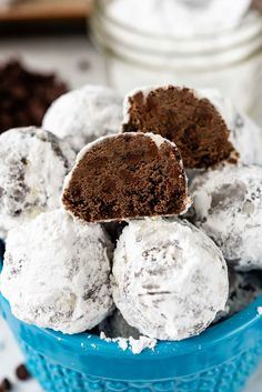 a blue bowl filled with ice cream and chocolate cake balls on top of a table