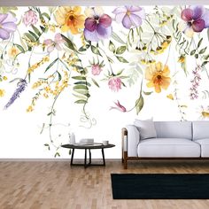 a living room with flowers painted on the wall