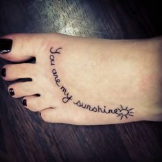 a woman's foot with the words you are my sunshinene on it and stars