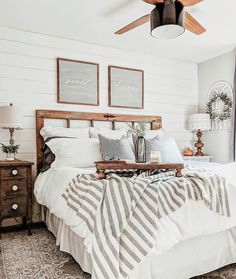 a bedroom with white walls and wood accents