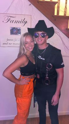 two people standing next to each other wearing cowboy hats