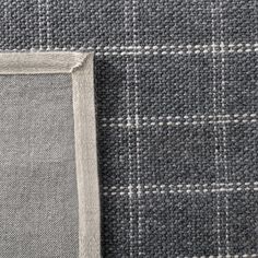 a gray and white checkered fabric with a square frame on the bottom right corner