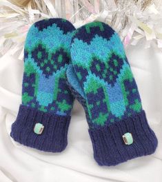 two knitted mittens sitting on top of each other