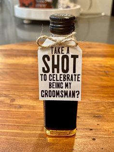 a bottle with a label that says take a shot to celebrate being my groomsman?