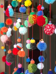 multicolored pom - poms hanging from the ceiling