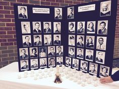 a table topped with pictures and candles on top of a white cloth covered tablecloth