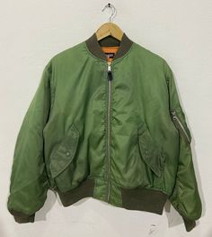 "*ITEM: Burch Scott US Airforce Type AM-1 Style Bomber Jacket Medium Vintage US Army Airforces Bomber Jacket Green Size M *ITEM DETAILS: 👇🏻 Please be aware that all vintage items will usually show a few signs of wear or fading due to age, but anything visible such as stains or holes, and serious flaws have been photographed.For any further information on this item please contact us and we will be happy to help. *SIZE:MEDIUM *ACTUAL SIZE MEASUREMENT: 👇🏻 *PIT TO PIT(WIDTH):22\"INCHES *LENGTH(F Khaki Combat Style Windbreaker For Streetwear, Green Combat Outerwear For Fall, Green Military Utility Jacket For Streetwear, Green Military Style Utility Jacket For Streetwear, Green Combat Style Outerwear For Outdoor Activities, Green Combat Style Outerwear For Outdoor, Green Techwear Utility Jacket For Streetwear, Green Zip Fly Outerwear For Outdoor, Green Outerwear With Zip Fly For Outdoor